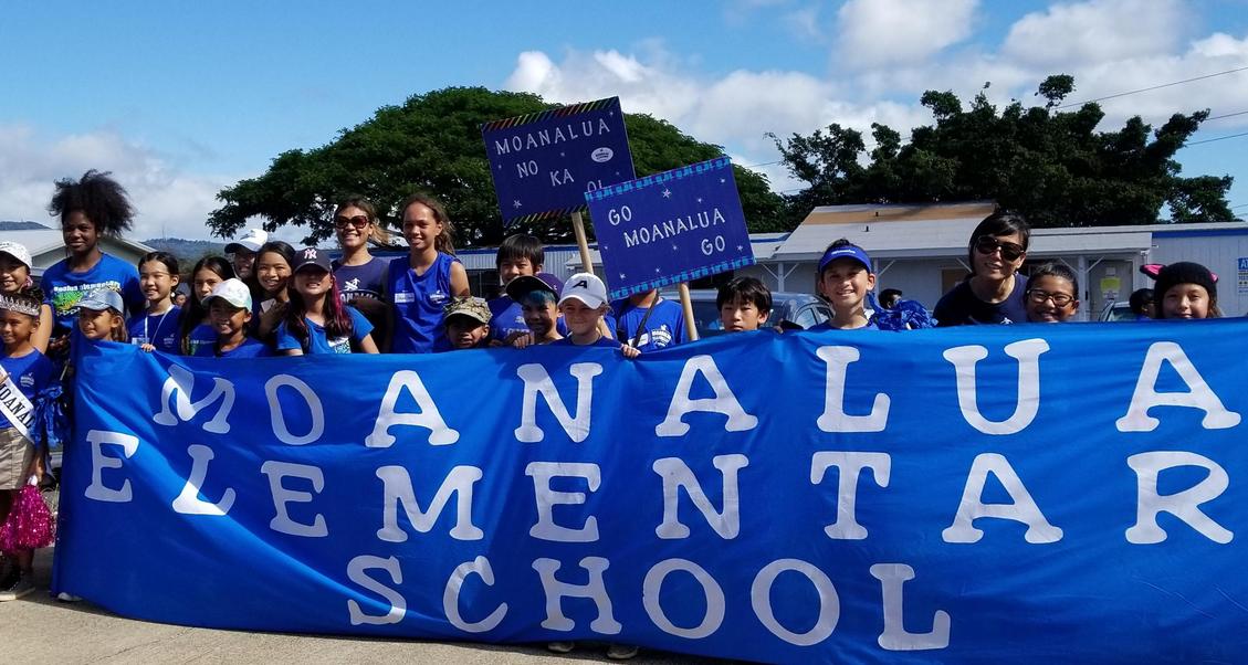 Student council holding Moanalua Elementary School banner