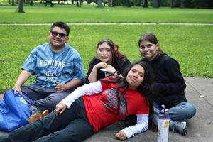 Students relax together outside.