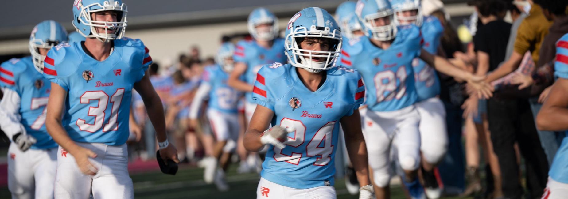 Football team runs onto the field
