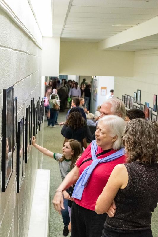 Crowd enjoying artwork on the gallery walls
