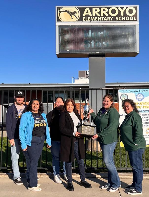 Arroyo staff holding trophy