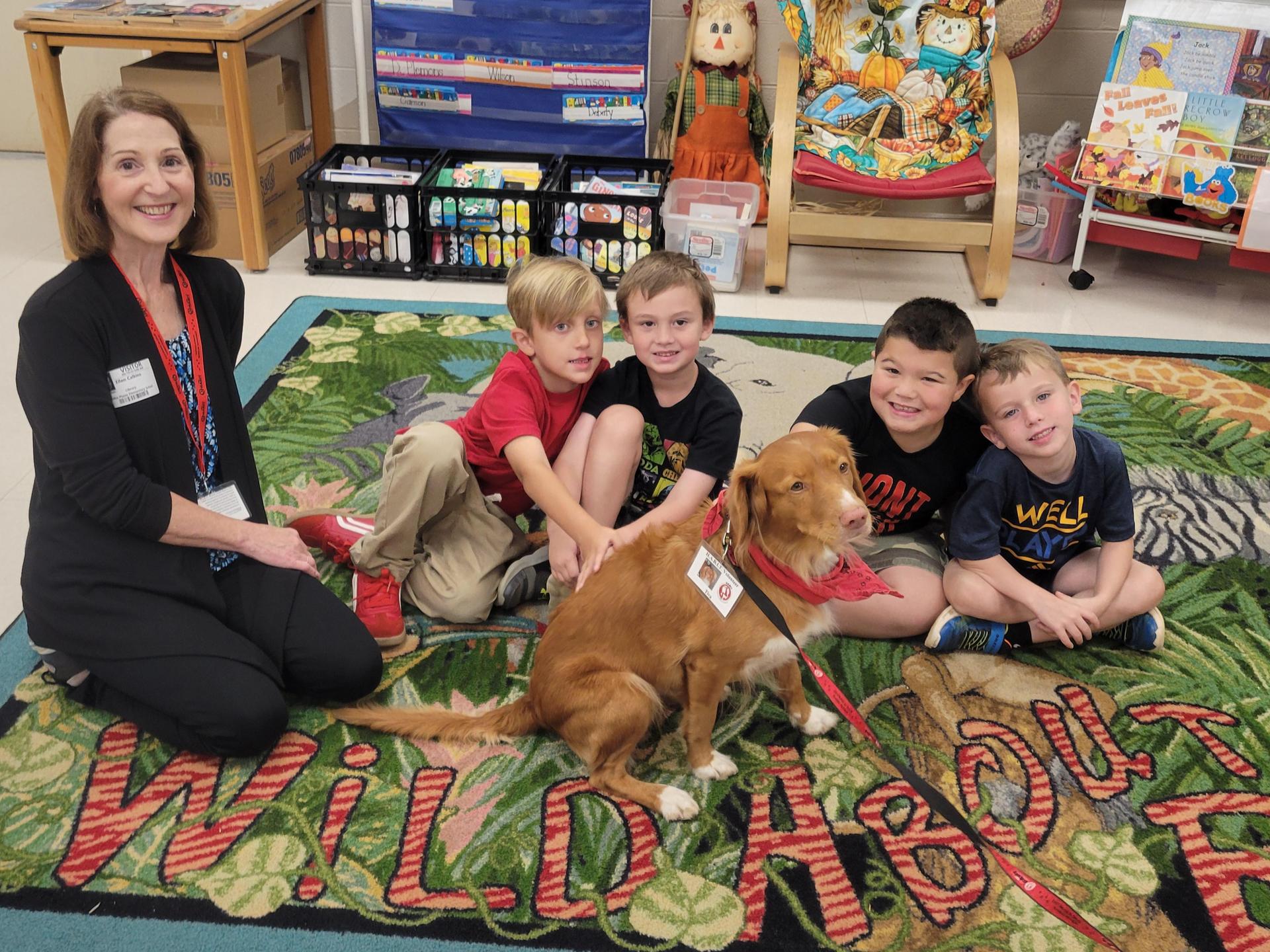Students reading with a dog in the library 