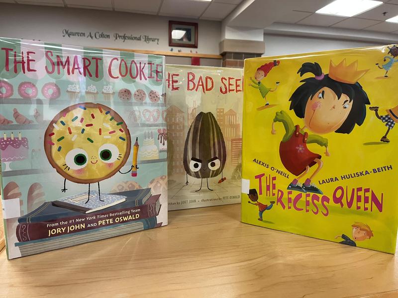 three children's books on display in a school library