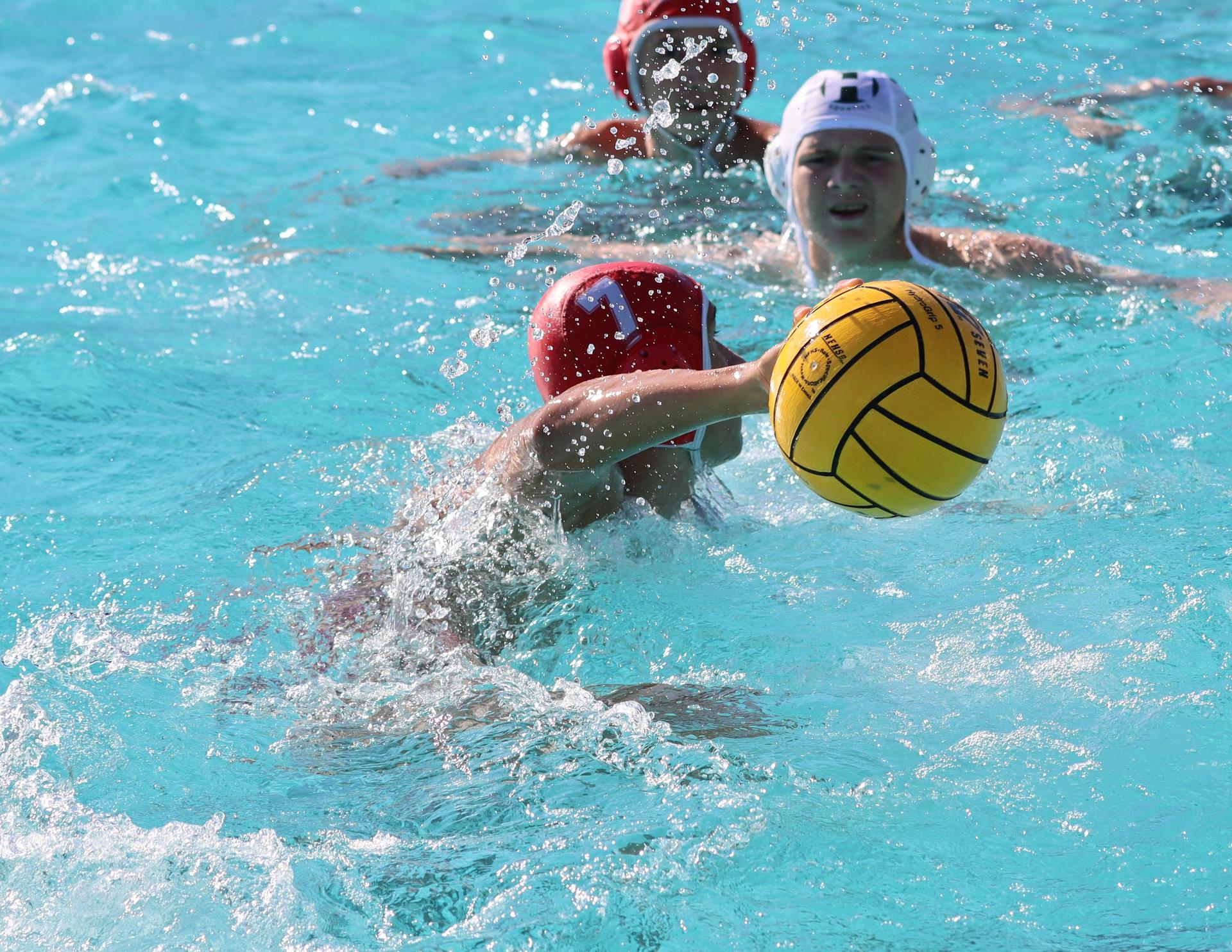 boys water polo players in action against hoover
