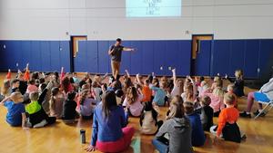 Students at Penn Yan Elementary listen as Stanley Tucker leads an engaging assembly focused on integrity, writing, and finding their voice.