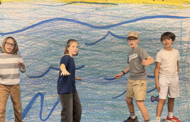 Screenshot of four students singing a song from movie musical