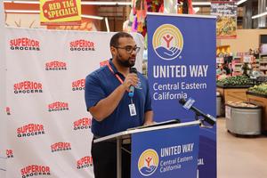 a man giving a speech in a grocery store