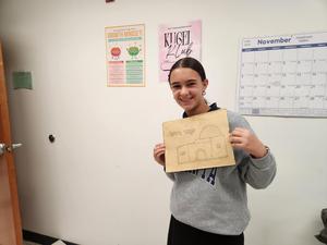 A student is proud to show her work.