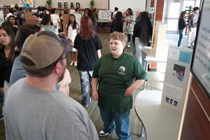 An IB student presents his research project to classmates