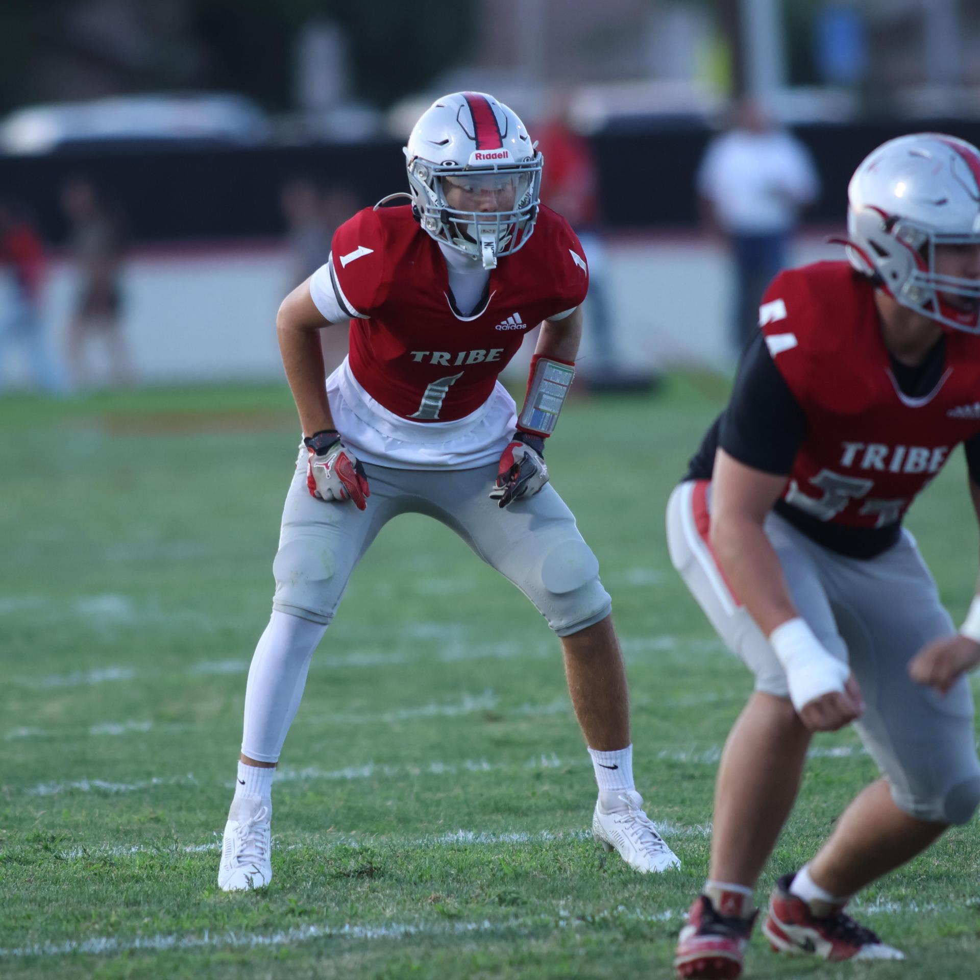 Varsity football players in action against Parlier 133