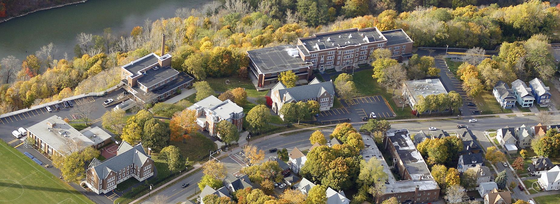 Aerial view of campus in fall with river running behind