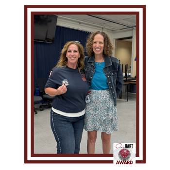 Photo of 2 women, 1 holding an award