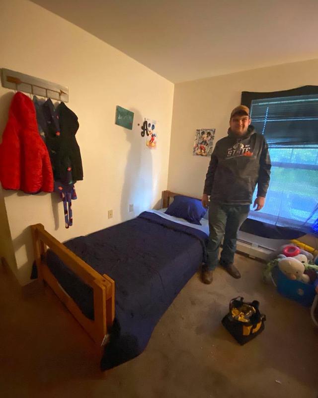 Student poses with bed he delivered to local family