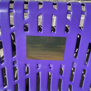 Purple bench with a memorial plaque for Margaret Charbonnier.