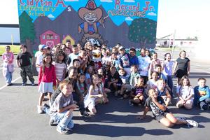 MSJC mascot, Ernie the Eagle with group of students in front of mural at Record Elementary