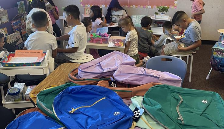 Student backpacks in a classroom.