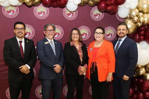 Five members of Whittier Union High School District’s Board of Trustees pose for a group photo in front of a District-branded backdrop decorated with burgundy, gold and white balloons.