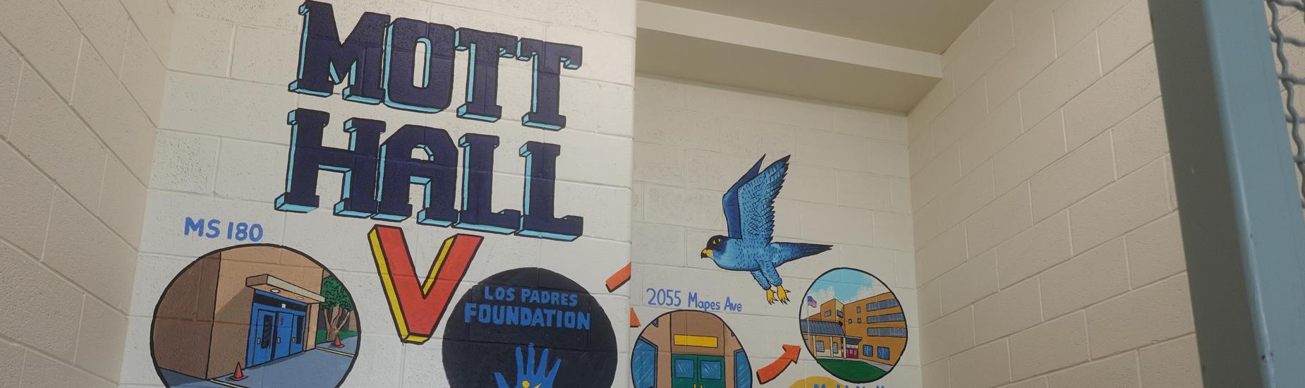 Mott Hall V mural in the stairwell displaying the school’s journey from MS 180 to its current 2055 Mapes Avenue location, with icons for the Los Padres Foundation and a falcon flying above the timeline.”