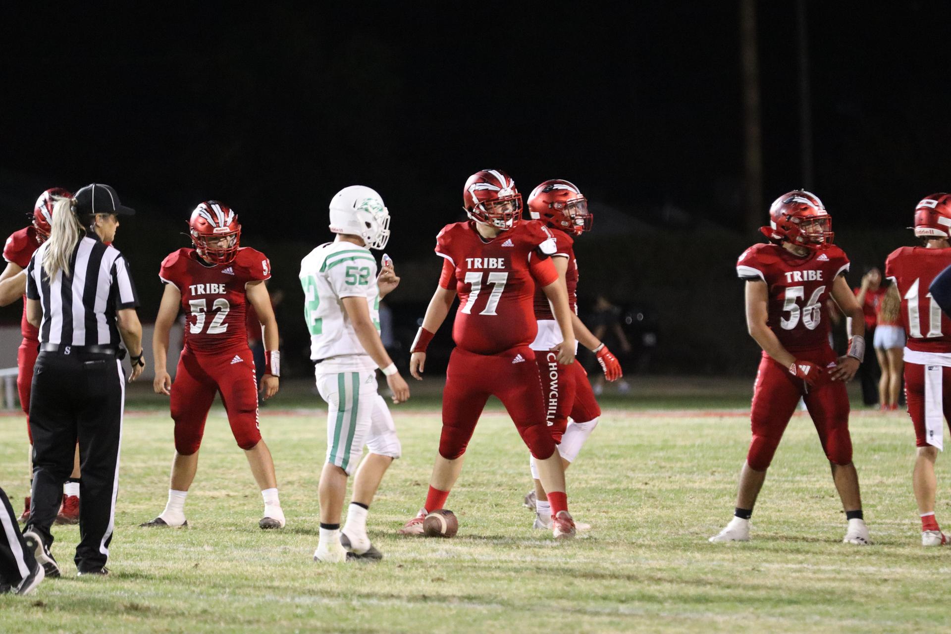 varsity football players in action against Riverdale