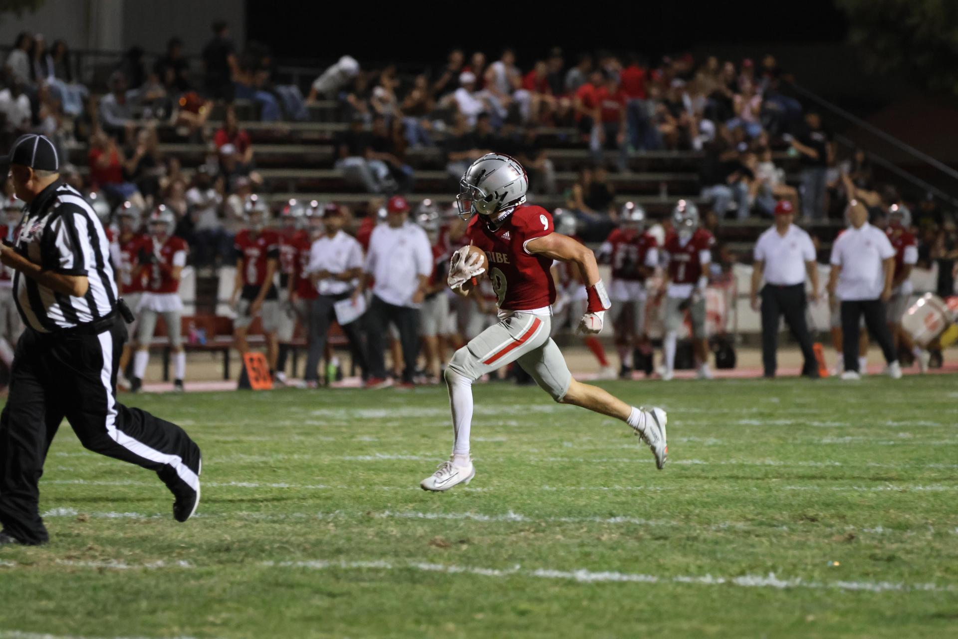 Varsity football players in action against Parlier 49