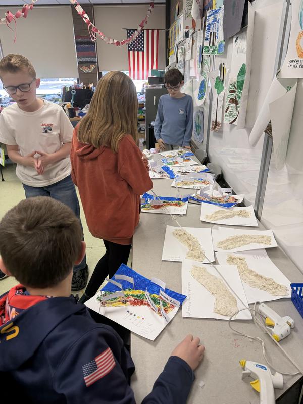 3d maps on table with students around the table