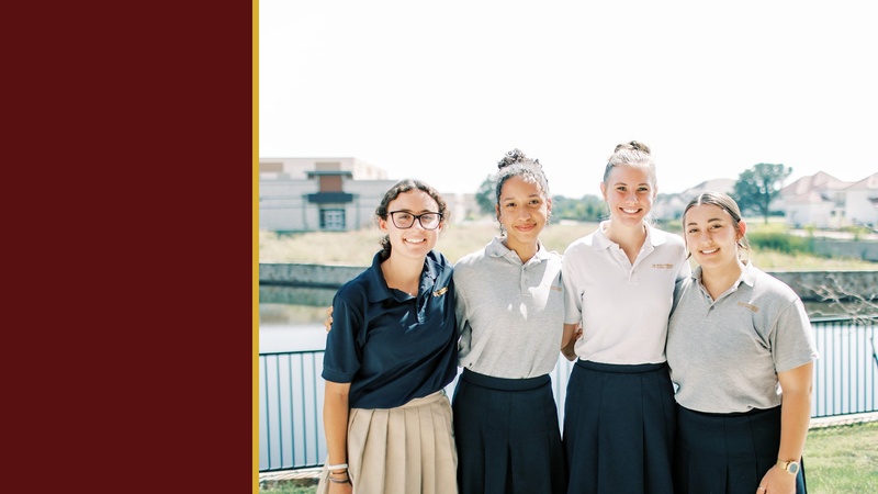 Four smiling high school students stand together outside