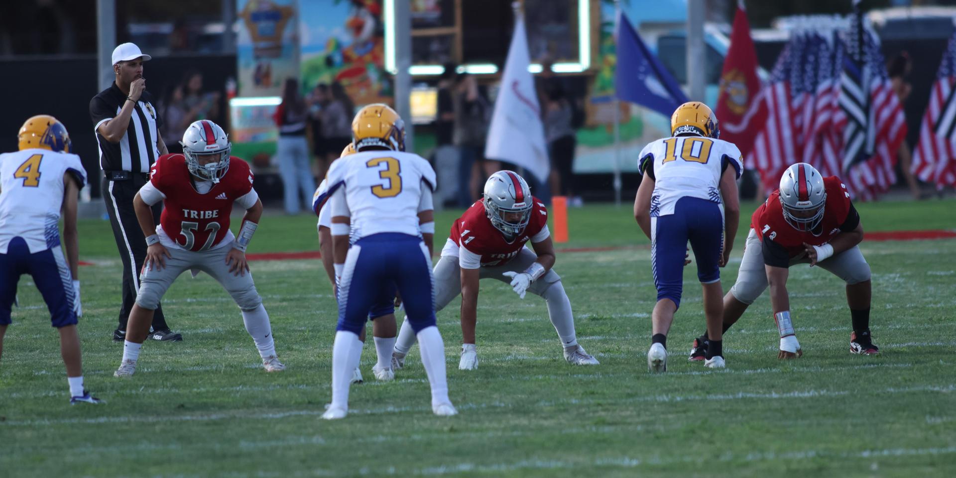 Varsity football players in action against Parlier 136