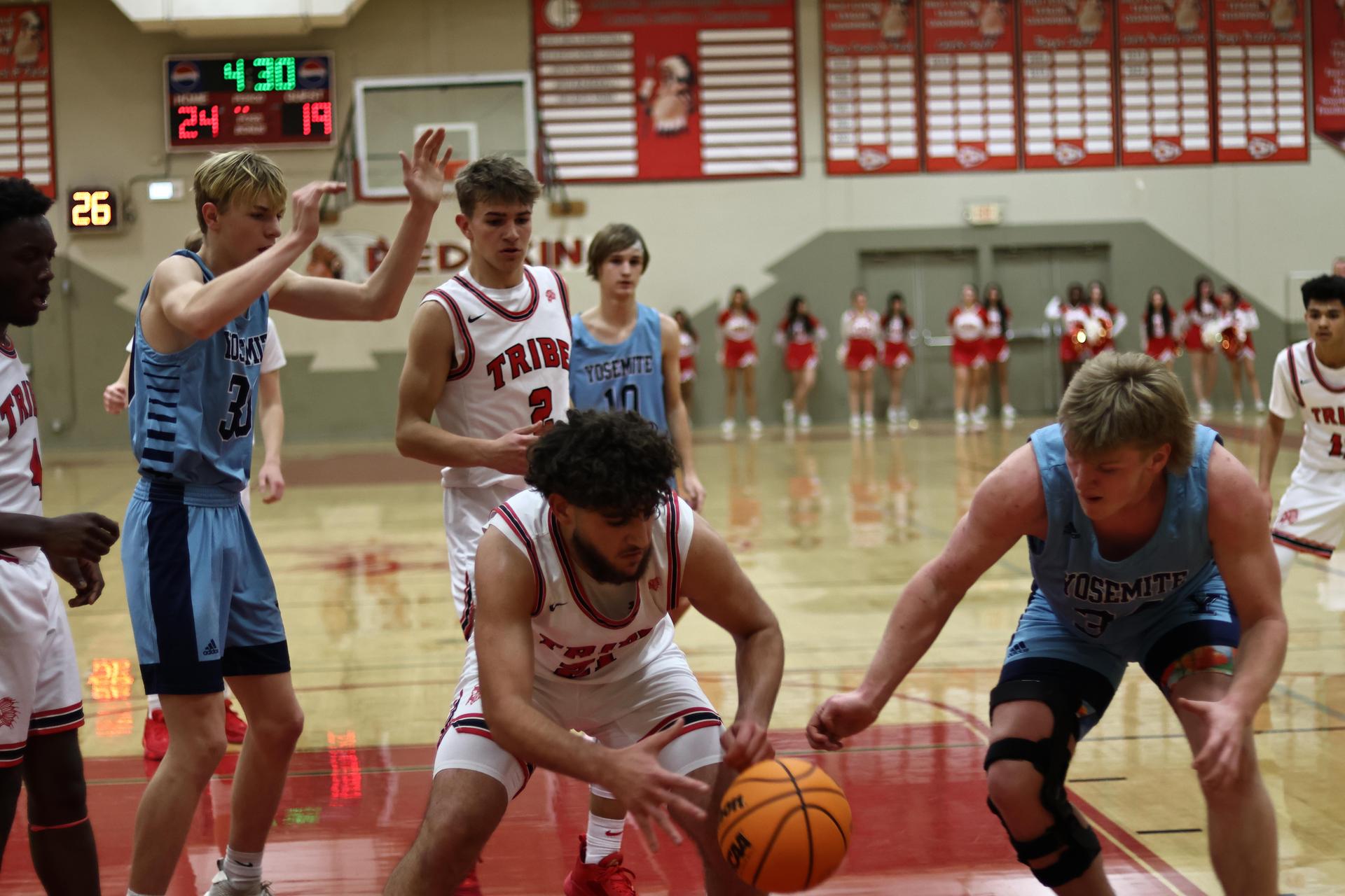 Varsity boys playing basketball against yosemite