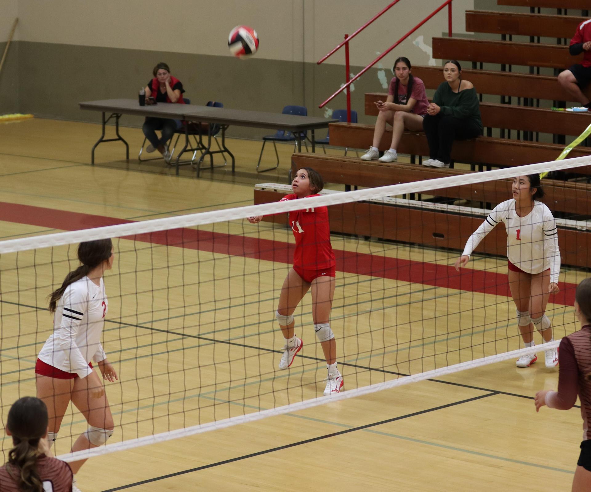 varsity volleyball players in action against Fresno Christian