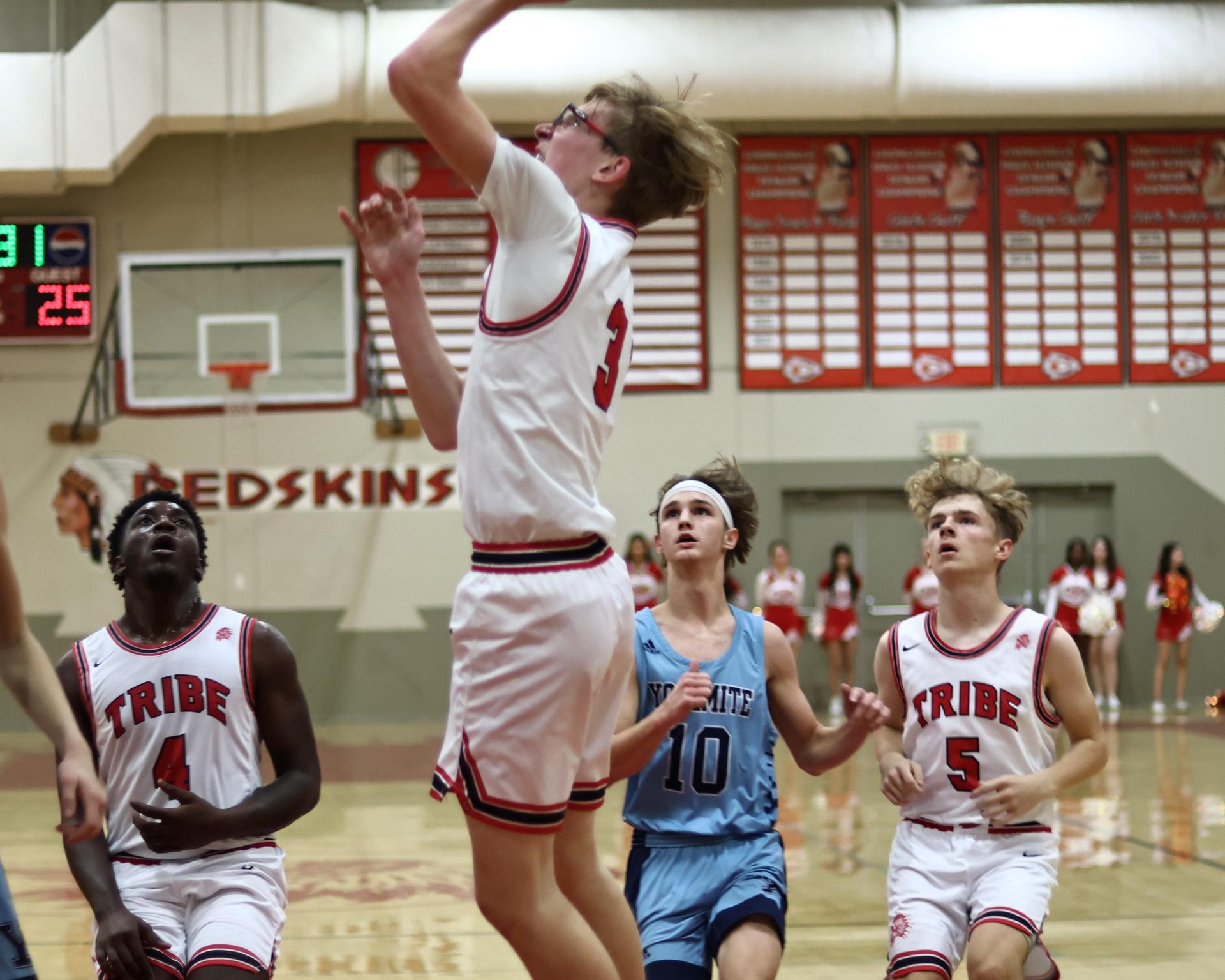 Varsity boys playing basketball against yosemite