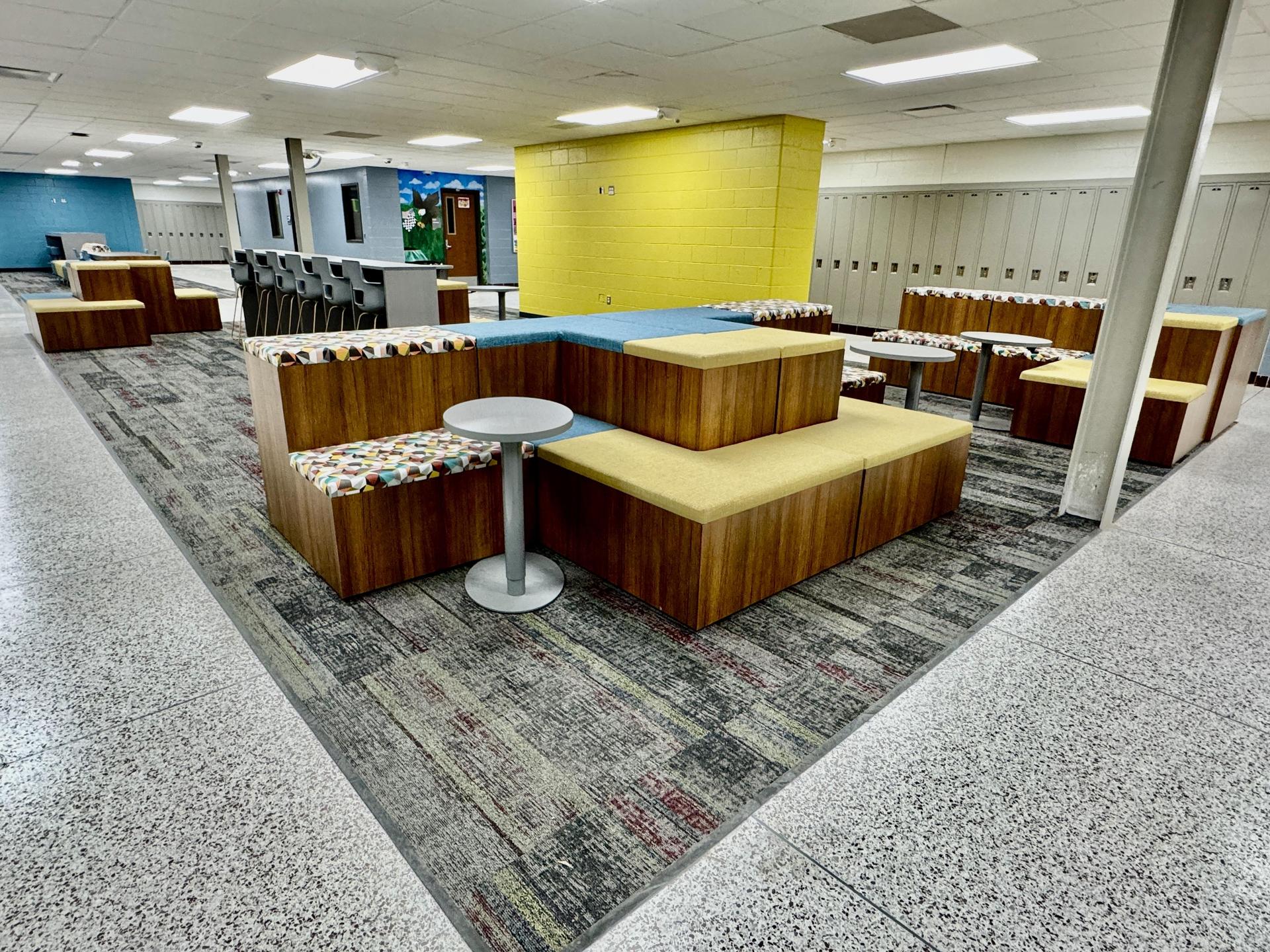 Bright yellow furniture in new collaboration space.