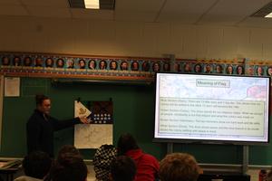 Girl standing next to a flag she created