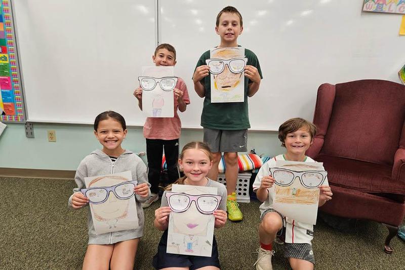 Students (Front) Ella DeFlavio, Aria Marrone, Landon Roberts, (Back) Silas Fox and Connor Leitch hold up their art projects