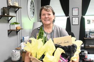 Mrs. Smith receiving her retirement gifts.