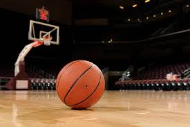 basketball on the floor of a court with net