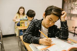 student sitting at desk doing school work