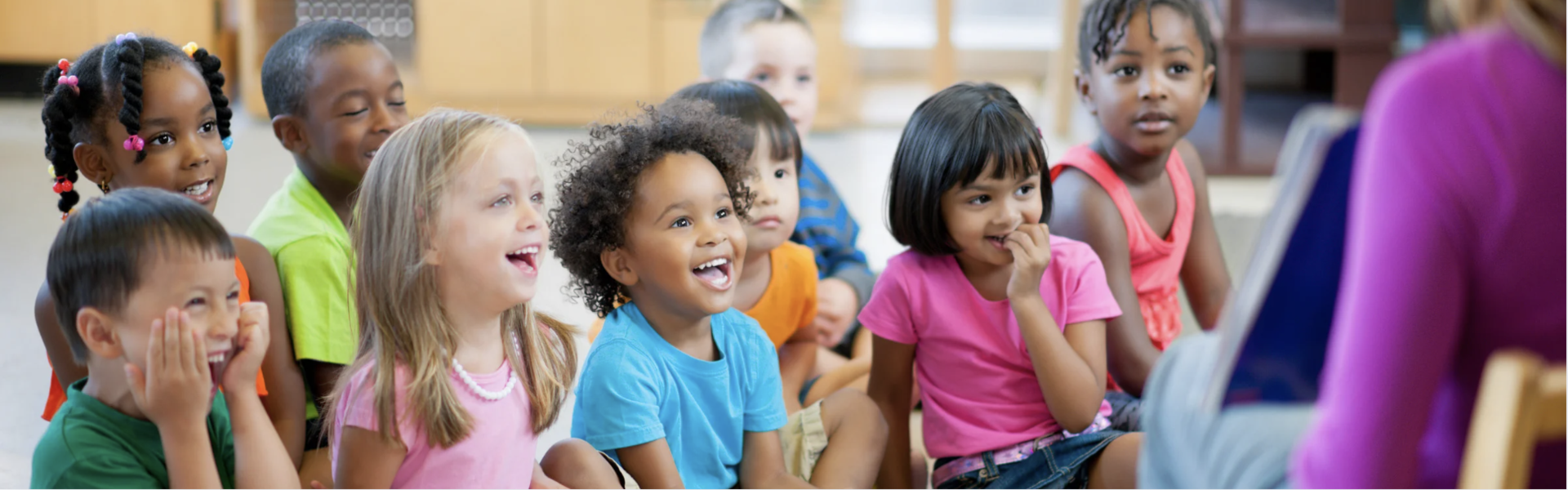 Diverse elementary age children in class looking joyful