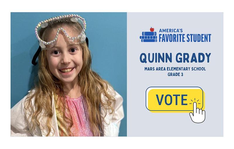 A girl in a lab coat with safety goggles on her head