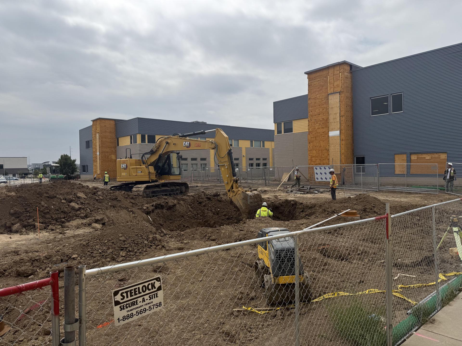 Quad construction; dirt moving activity with excavator