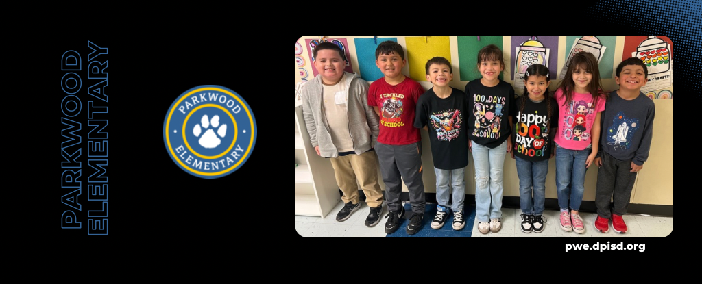 A group of eight elementary students smiling in front of a colorful mural.