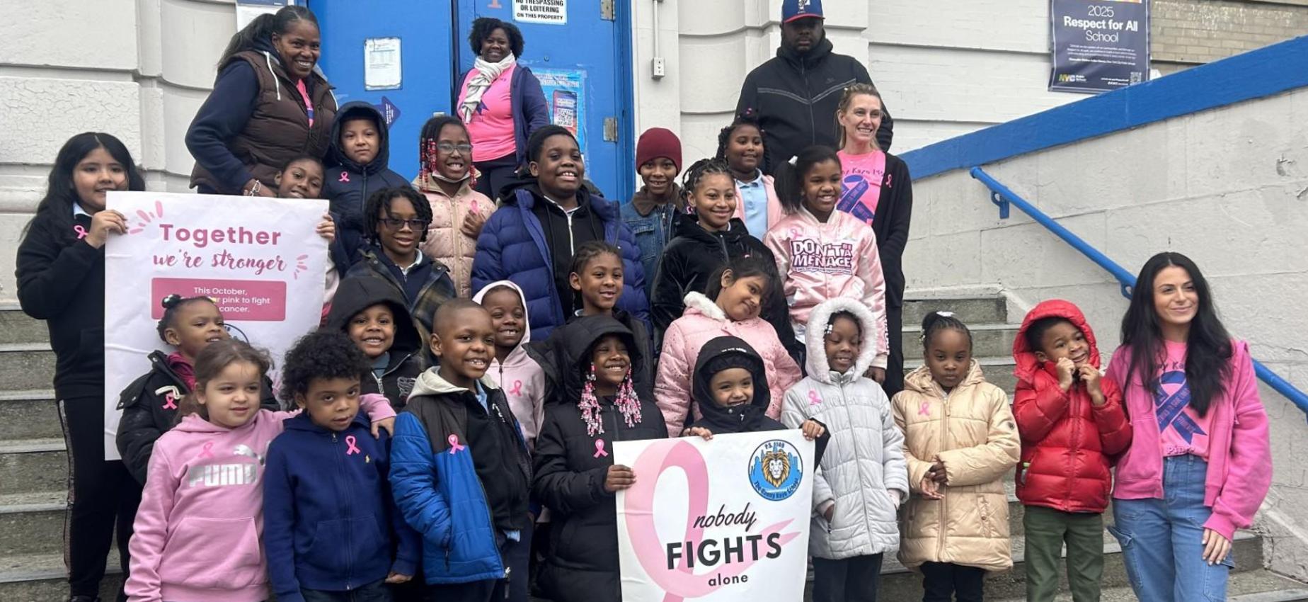 class photo in front of school for breast cancer awareness