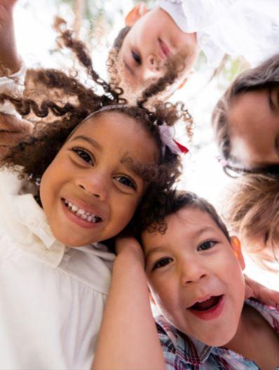 children in a circle looking down