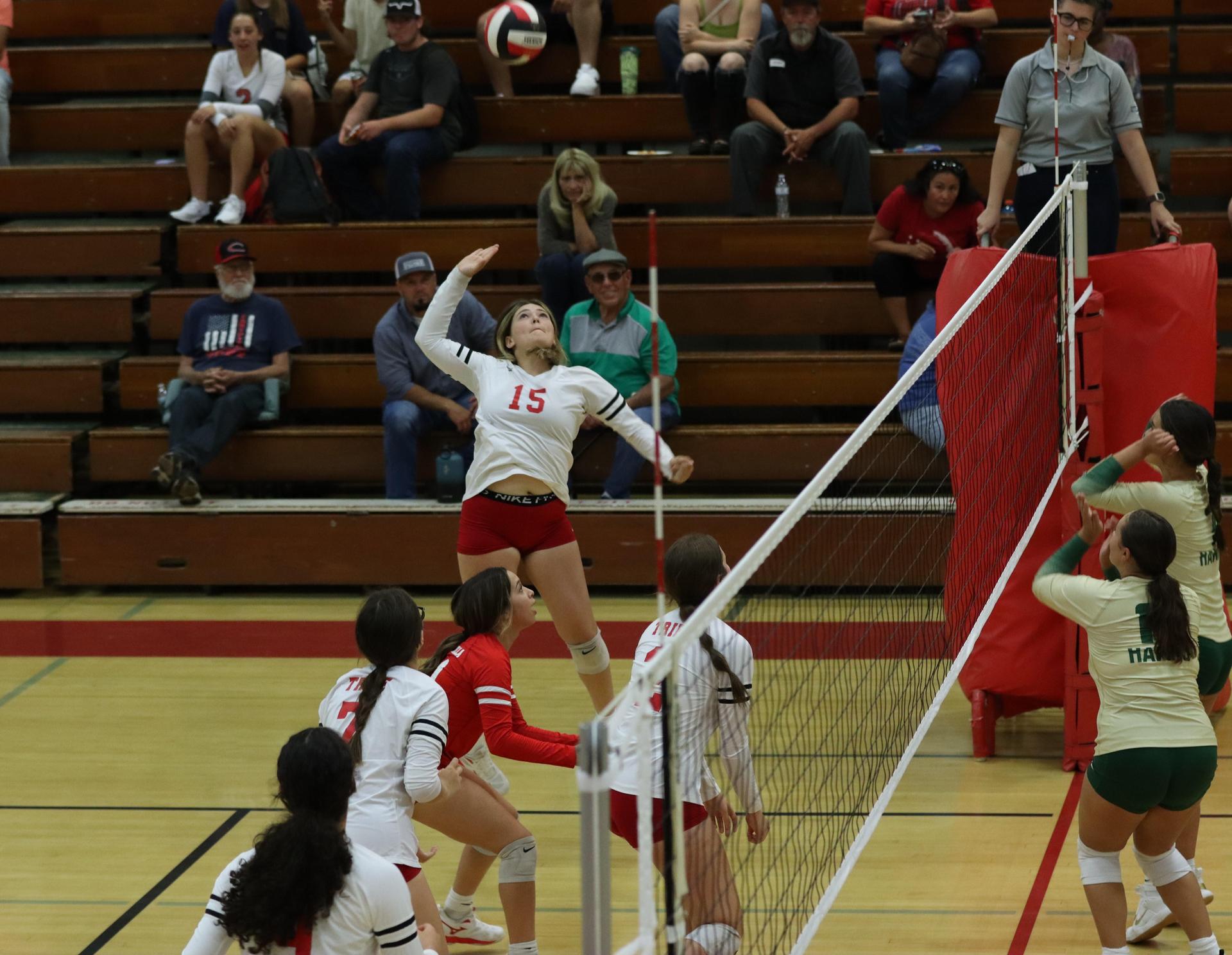 varsity volleyball players in action against liberty