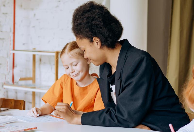 teacher and student at table