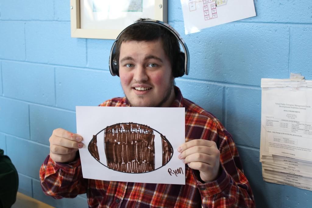 Student holding a colored picture