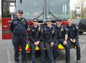 group of firefighters on fire truck