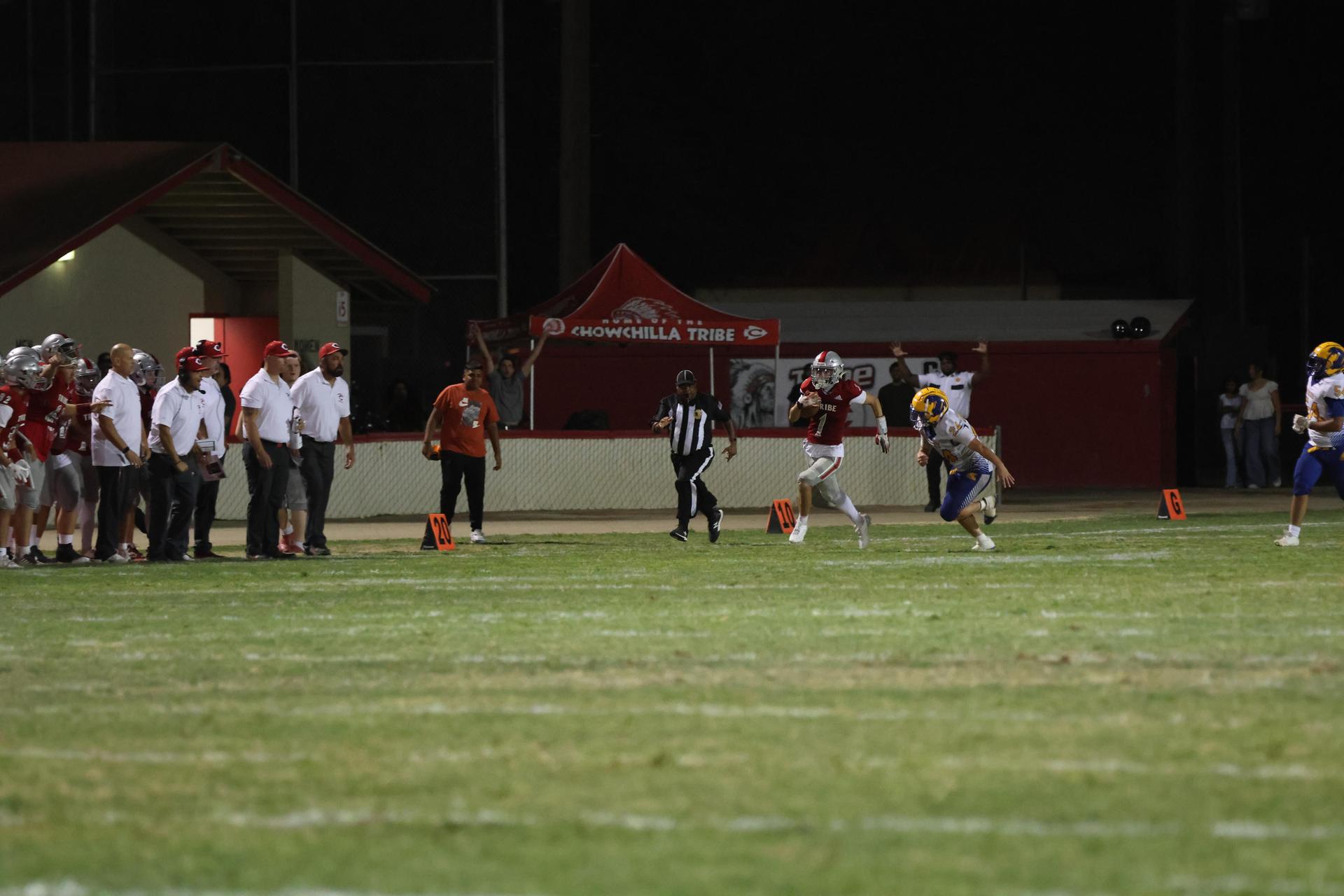 Varsity football players in action against Parlier 44