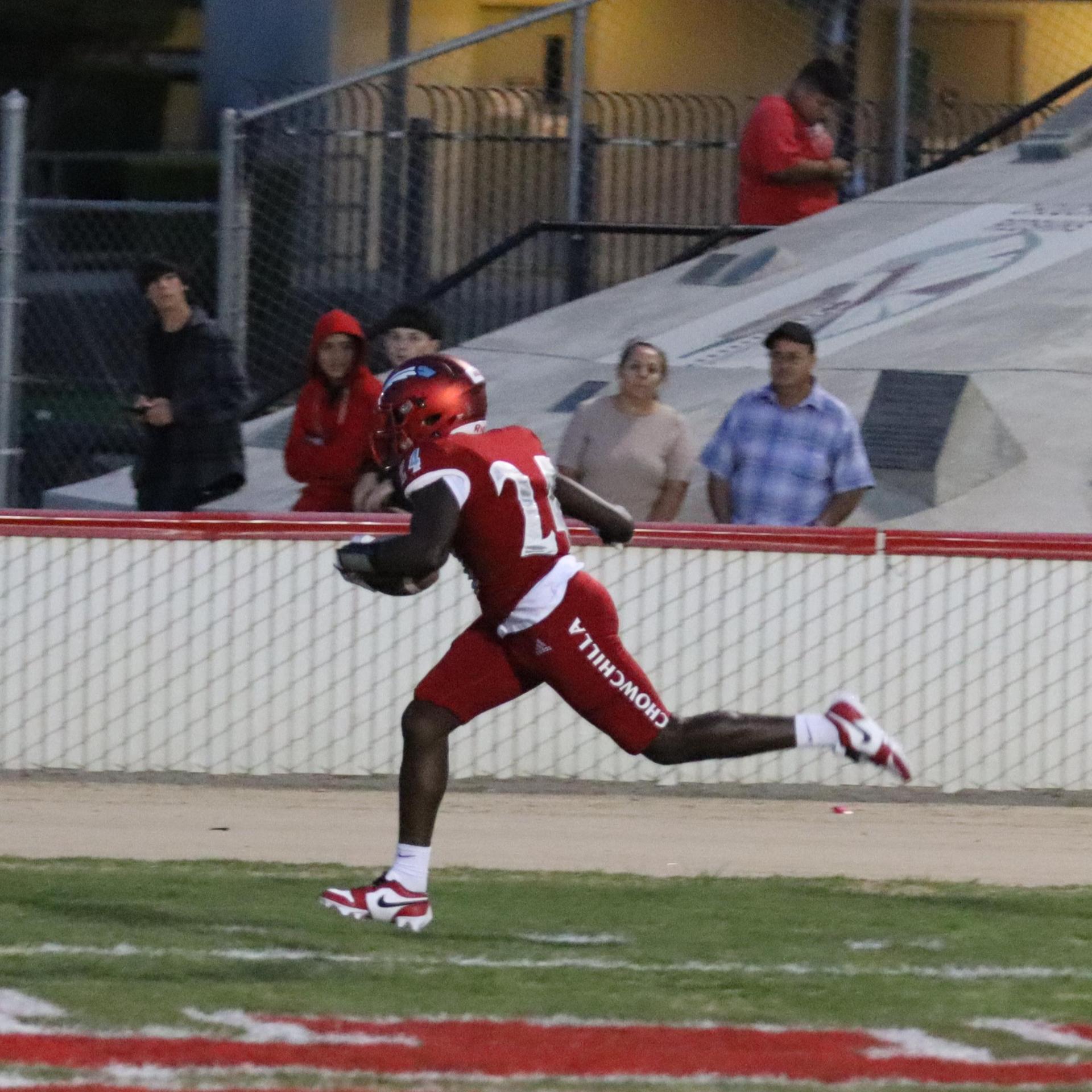 varsity football players in action against Riverdale