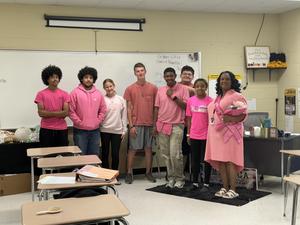 Students in pink stand with Ms. Elzie