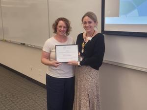 Shannon Decker with Trustee Petrino holding award